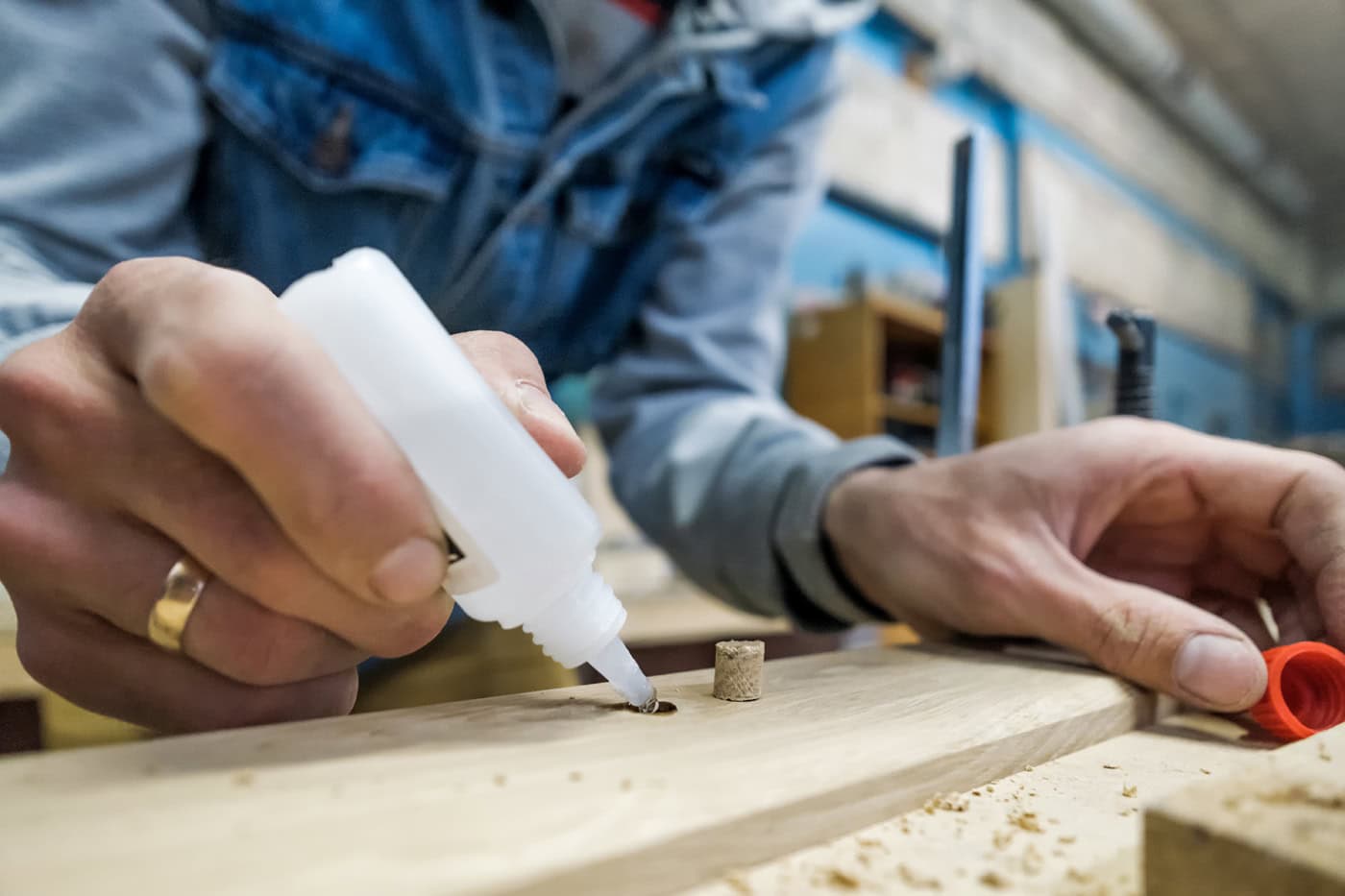 Person using cyanoacrylate adhesives on wood for assembly application